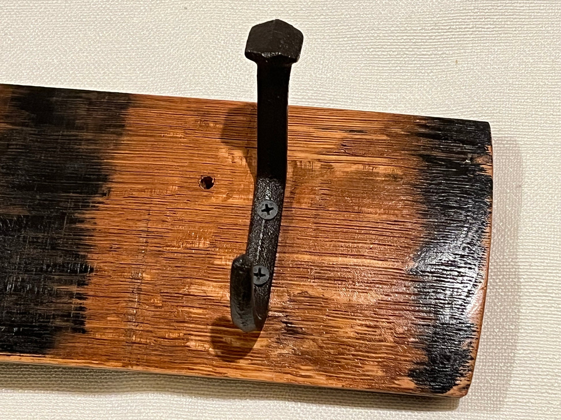 Coat rack, bourbon barrel stave, 4 rustic hooks, black bent railroad ties nail, closeup